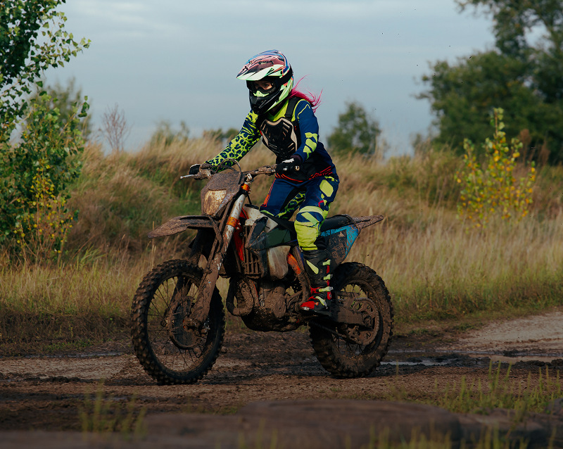 Motocross rider on a muddy track.