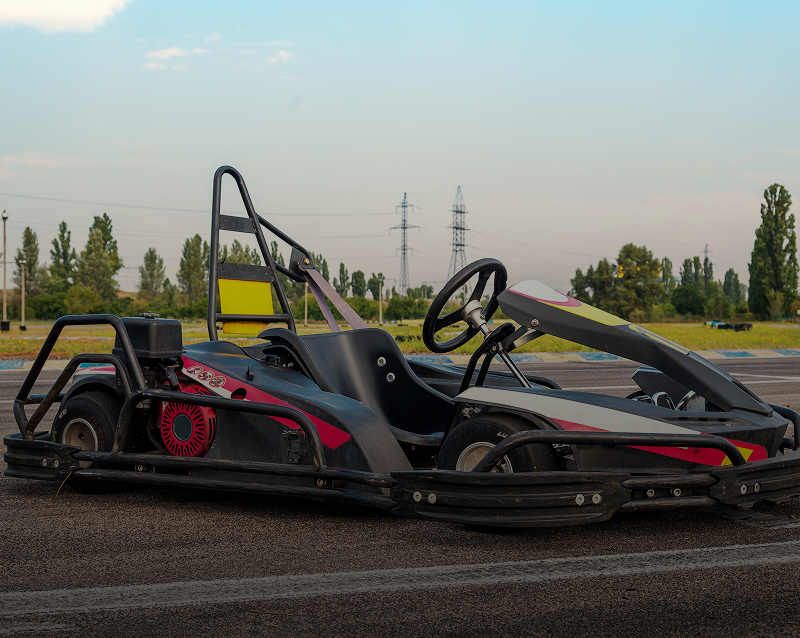 Go-kart parked on outdoor track.